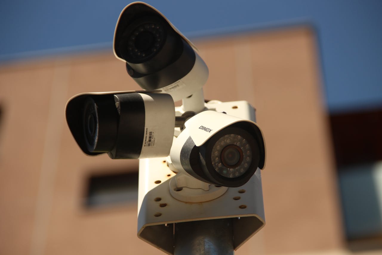 why-choose-us High-resolution surveillance cameras installed in a city environment for security purposes.
